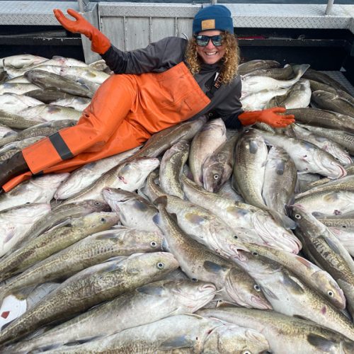 Woman on top of a lot of fish